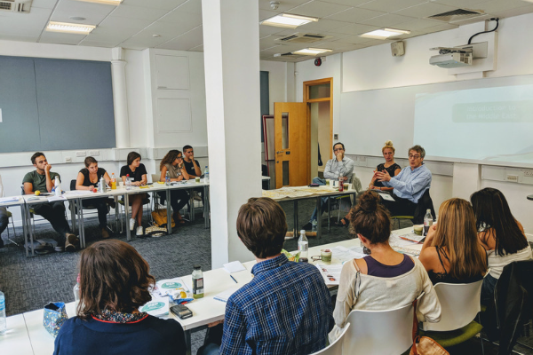 Photo of late Guardian Middle East Editor, Author and Academic Ian Black speaking to a group of students at a Solutions Not Sides student leadership programme event.